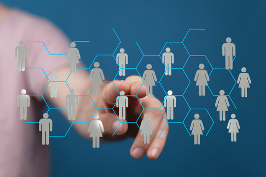 Abstract conceptual image depicting digital network, collaboration and communication. A hand touches a graphic representation of connected peopl