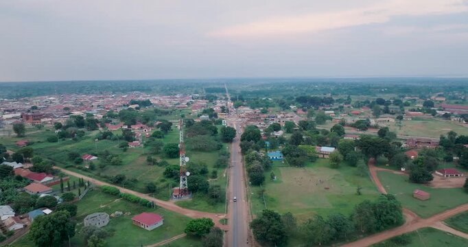 Aerial view of roads cutting through lush green landscapes, interspersed with buildings, creating a tapestry of urban and rural life, Kumi, Eastern Region, Uganda.