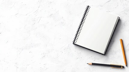 A blank spiral notebook and two pencils are arranged on a textured white surface, viewed from directly above.