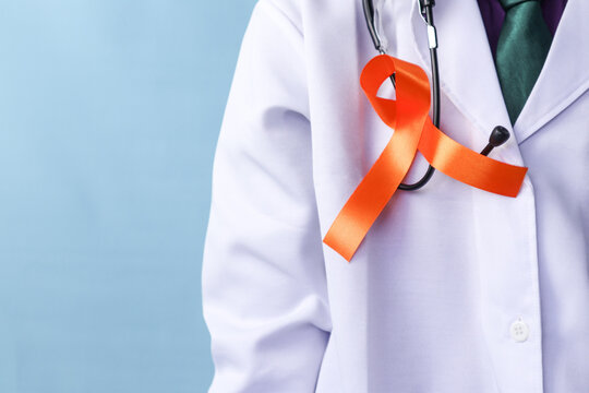 A doctor is wearing a leukemia or a kidney cancer ribbon on an isolated background