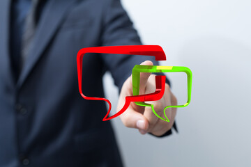 Businessman interacting with digital speech bubble icons for communication and feedback in business. Connecting technology idea.