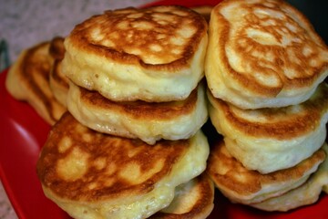 Delicious pancakes for breakfast on a red plate
