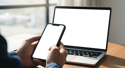 Cell phone and laptop white screen mockup,blank screen while working on laptop at office,Woman hand holding mobile phone Business woman using smartphon