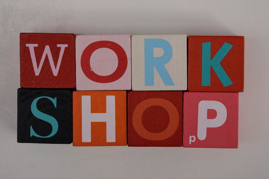 Colorful wooden blocks spelling the word 'WORKSHOP'. Perfect for illustrating teamwork, educational concepts, creative learning environments and