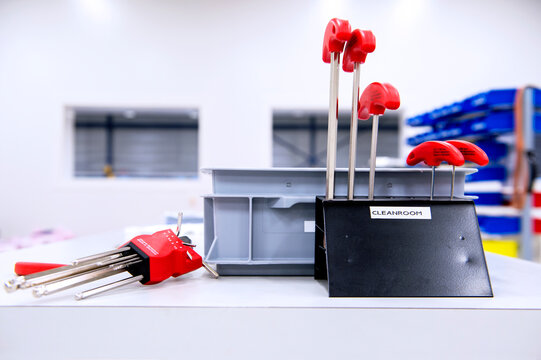 Assorted set of Allen keys on a table and in a designated stand in a clean room, used for the assembly of high performance semi-conductor equipment.