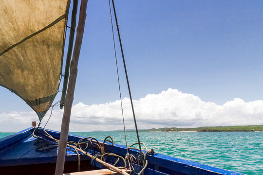 A traditional sailing boat with one sail up, on a calm sea in Antsarinana, north Madagascar 