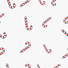 Red and white striped candy canes on minimalist holiday seamless pattern