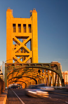 Tower Bridge at sunset, Sacramento river road bridge, tall towers and rows of arches over the road. 