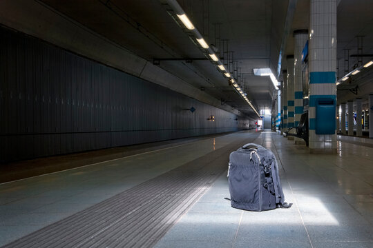 Backpack left unattended on an underground railway station in plain sight, under a spotlight.