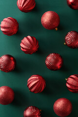 Christmas decoration ornaments on green background viewed from above. Top view
