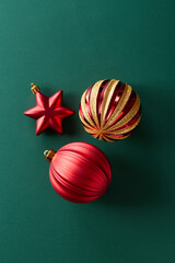 Christmas decoration ornaments on green background viewed from above. Top view. Copy space