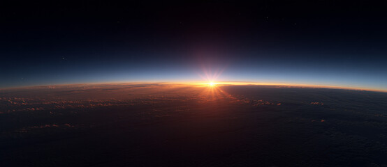 Stunning sunrise above thick cloud layer from airplane window at high altitude