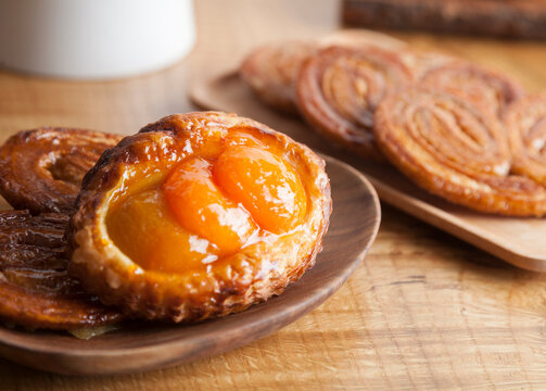 Homemade pastries, an apricot fruit flan and baked palmiers 