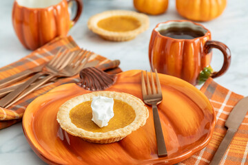 Enjoying pumpkin pie with coffee in autumn-themed kitchen setting