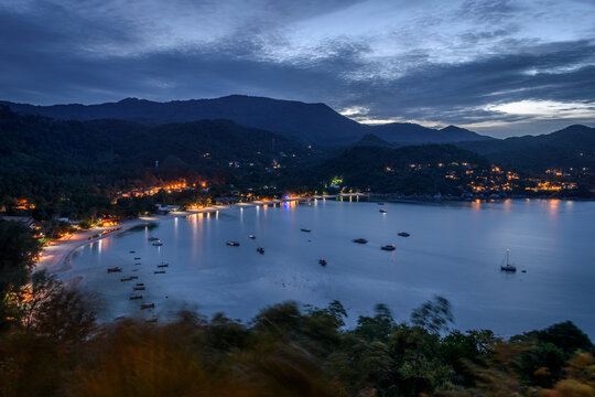High angle view of fishing boats moored in a bay at sunset.