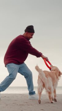 Funny African American man fights for rubber ring with dog