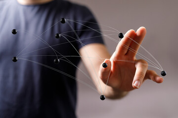 Close-up of a man's hand interacting with a network diagram. Representing concepts such as connection, communic