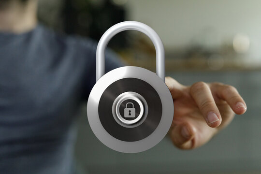 A person holding a silver padlock representing concepts such as security, privacy, and protection. Symbol of sa