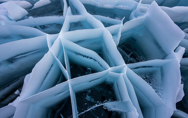 Intricate patterns of fractured blue ice with sharp edges and deep crevices