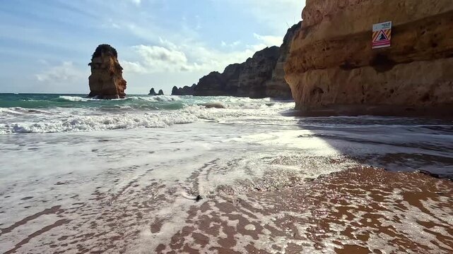 Waves and Cliffs on Praia Dona Ana Beach in Lagos Algarve Faro Region Southern Portugal Sunny Day Still 4K GoPro Travel Footage