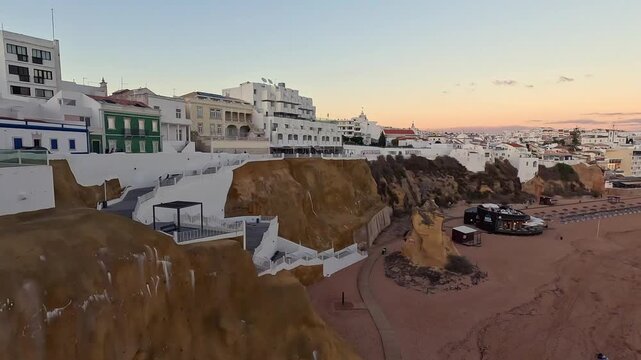 Panoramic Sunset View of Albufeira Beach and Old Town from Top of Cliffs Algarve Faro Region Southern Portugal Slow Pan 4K GoPro Travel Footage