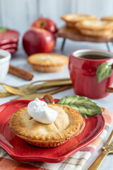 Delicious apple pie with whipped cream served on a festive table in autumn