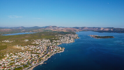 Mediterranean Landscape Vista: Scenic panorama of rolling hills covered in dense foliage against a clear horizon of ocean and archipelago