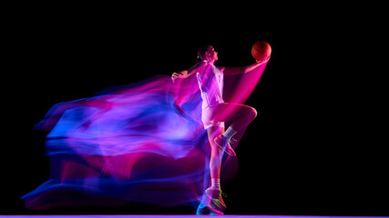 Female basketball player mid-air holding glowing ball with motion blur. Concept of athletic energy, fitness campaigns, advertising visuals, and motivation for active lifestyle brands.