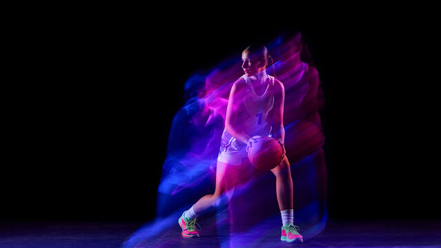 Female athlete holding basketball in glowing colorful motion blur. Concept of modern fitness, active lifestyle branding, body in motion, and women empowerment visuals. - Powered by Adobe
