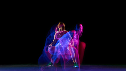 Focused basketball player dribbling with glowing neon trail. Concept of sports ads, brand visuals for active lifestyle products, coaching programs, and digital training materials.