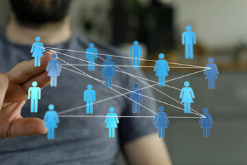 Close-up of a hand with connected digital human icons representing a network, community, or social media connec