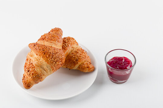 Delicious and sweet croissant with strawberry jam
