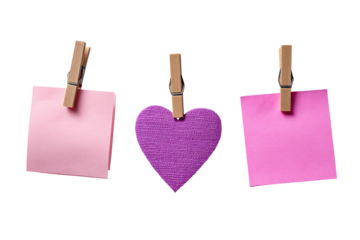 Three pink sticky notes, one with a purple heart, attached by wooden clothespins