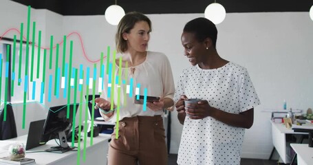 Two coworkers walking office tablet rotating showing data bars and waves reviewing business metrics - Powered by Adobe