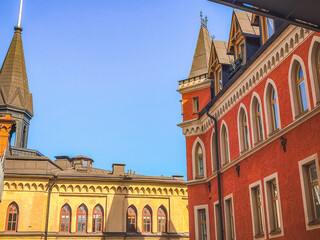 Obraz premium rooftops and building facades in red and yellow colors in central Stockholm