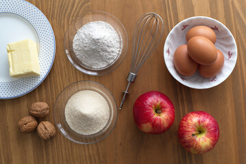Rustic flat lay of ingredients for baking apple cake