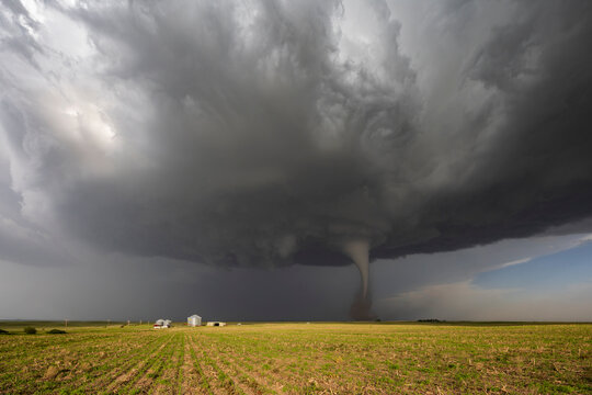 Fully Condensed Tornado, a rotating column of air reaching to the ground, a defined shape. 