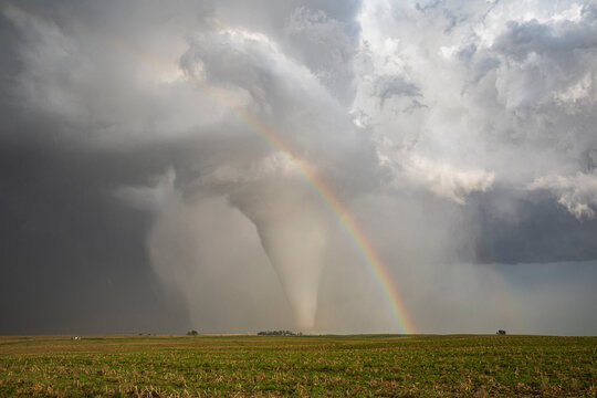 Fully Condensed Tornado with a Rainbow, a spiralling column of air reaching the ground. 