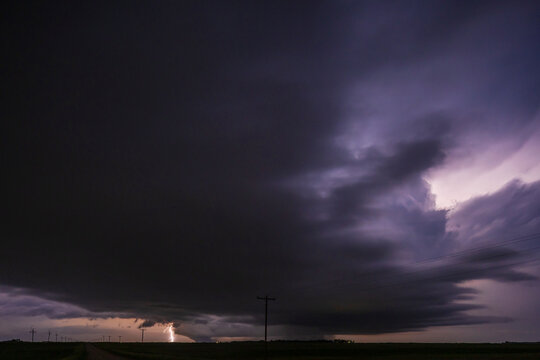 Fully Developed Wedge Tornado on the Ground after Sunset with  Lightning in the Supercell