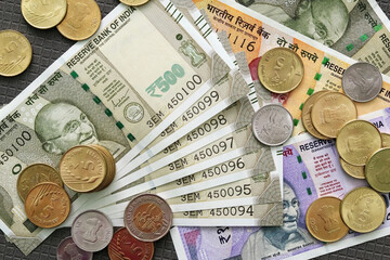 Close-up top view of Indian rupee notes (INR) and coins of different values. Concept of cash savings, financial profit and security, Indian economy.