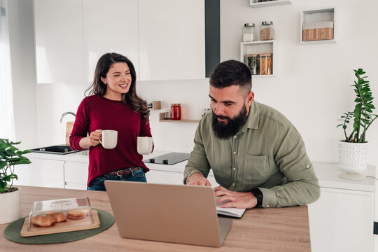 Couple working from home in kitchen - Powered by Adobe