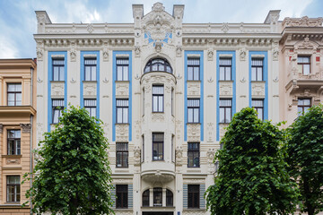Albert Street, apartment buildings along the street designed by the architect Mikhail Eisenstein, a building facade with decorative stonework and blue painted panels. 