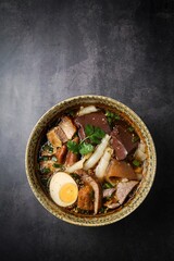 Chinese rolled noodles with crispy pork and egg in black soup,Rolled Rice Noodles in Five-spices Broth , Chinese noodles, thai called kuay jap