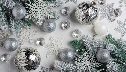 Festive Silver Christmas Ornaments and Snowy Green Branches.