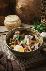 Chinese rolled noodles with crispy pork and egg in black soup,Rolled Rice Noodles in Five-spices Broth , Chinese noodles, thai called kuay jap