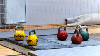 Old kettlebells stand in a row before a kettlebell lifting competition.