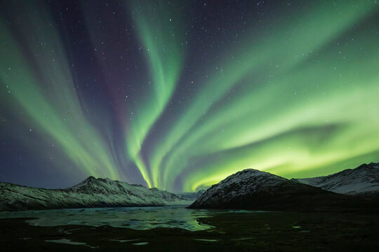 Aurora Borealis, the natural light display in the sky caused by charged particles from the sun colliding with gases in Earth's atmosphere, northern lights.