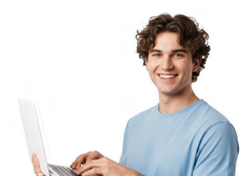 Young man with curly brown hair smiling while typing on a laptop computer against a solid black background