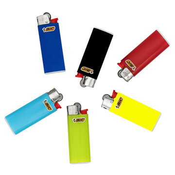 Six colored disposable BIC lighters,scattered arranged,product isolated.