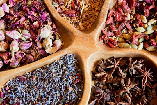 Pot pourri, dried flowers, star anise and seeds in a wooden bowl